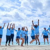 We Trippin Travel team jumping on the beach